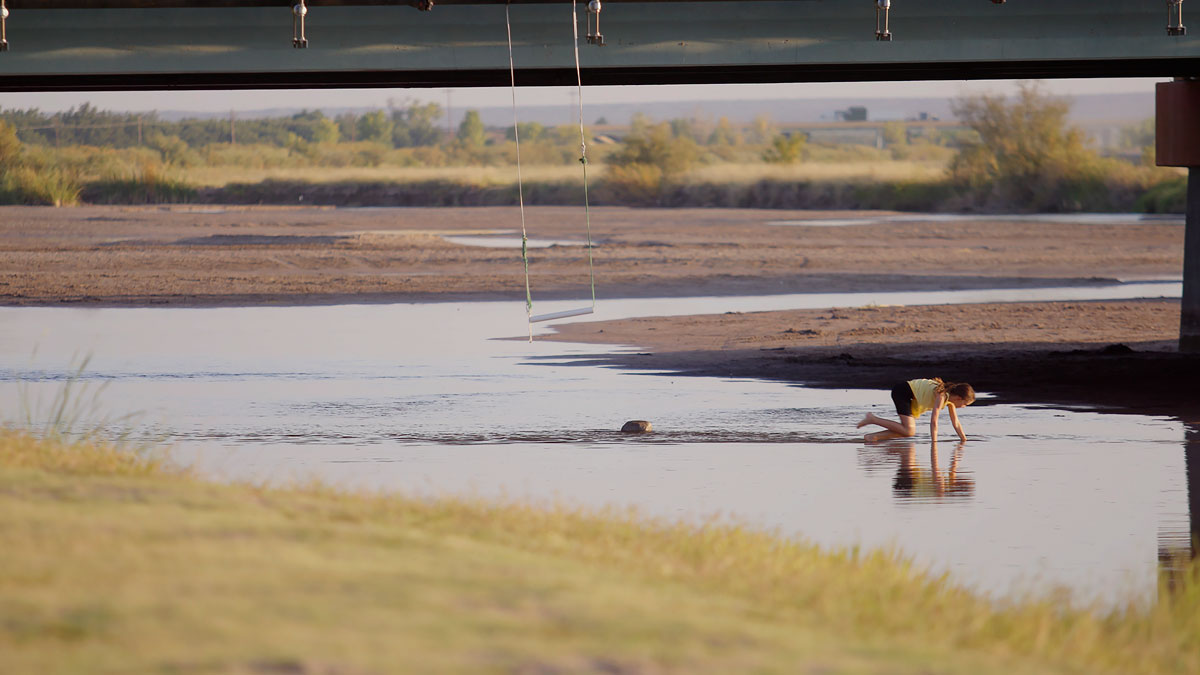 Young girl playing in the Rio Grande river.