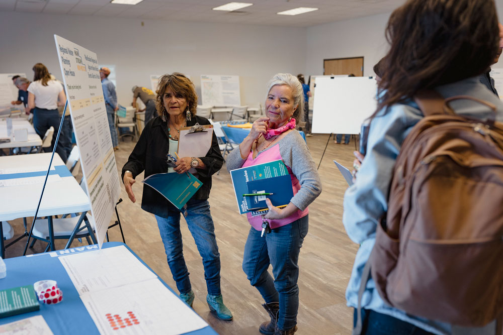 Three women at a Water Planning Open House